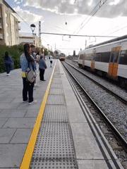 Morning trains serve passengers at Calella station platform