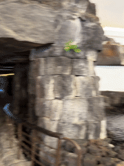 Tourist documents volcanic architecture venues across San Bartolomé, Spain