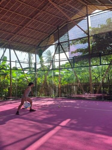 Woman plays padel on pink court in General Luna