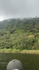 Boat tour documents Lake Beratan construction, mountain scenery