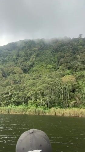 Boat tour documents Lake Beratan construction, mountain scenery