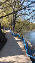 Morning angler fishes from Moscow boardwalk on sunny day
