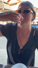 Woman enjoys fresh seafood at Thai coastal market
