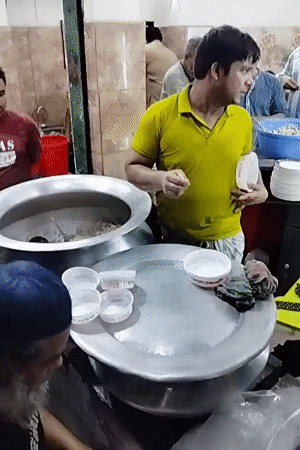 Communal meal served from large pots in Dhaka