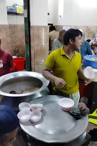 Communal meal served from large pots in Dhaka