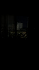 Nighttime cityscape viewed from apartment window in Bat Yam