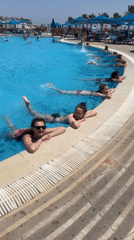 Women participate in morning water exercise at Sharm El Sheikh resort