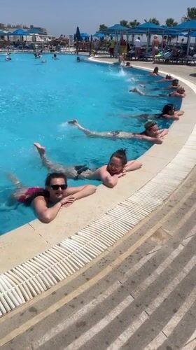 Women participate in morning water exercise at Sharm El Sheikh resort