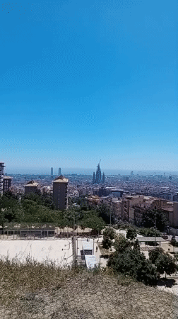 Clear skies frame Barcelona's sprawling cityscape in morning footage