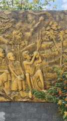 Golden relief sculpture depicting children documented in Lạc Dương