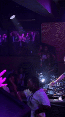 Person dances at purple-lit Paris nightclub