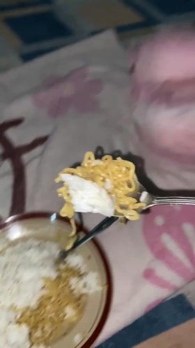 Young girl enjoys rice and noodle meal in Indonesia