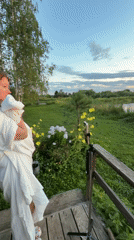 Sunset ritual on a Russian lake dock, white fabric, golden hour.