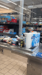 Grocery items on a conveyor belt at a Saint-Galmier checkout