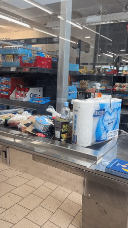 Grocery items on a conveyor belt at a Saint-Galmier checkout