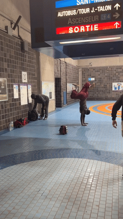 Man performs handstand in Montreal subway station