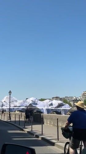 Cyclist spotted on sunny Paris street near river