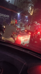 Delivery motorcycle navigates Surabaya streets at night