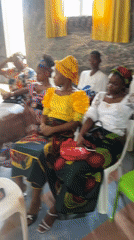 Women gather in traditional dress at Aba community meeting