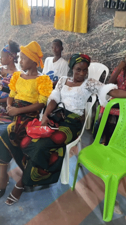 Women gather in traditional dress at Aba community meeting