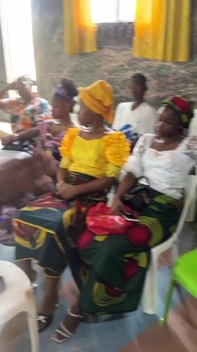 Women gather in traditional dress at Aba community meeting