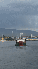 Ferry departure and port activity along the Melaya waterfront