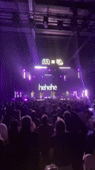 Live band plays purple-lit Moscow stage before packed crowd
