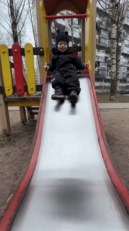 Toddler plays at playground and soccer field in Saint Petersburg