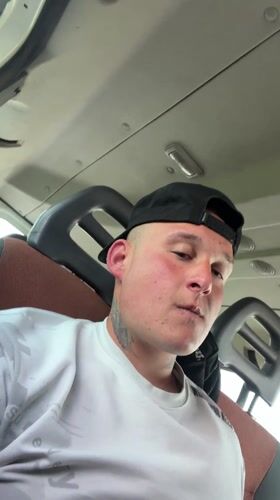 Man in baseball cap observed in vehicle passenger seat