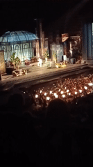 Live stage event under the Verona skyline, audience phones lit up
