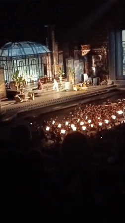 Live stage event under the Verona skyline, audience phones lit up