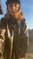 Woman poses for photo in sunny Podshivalovo backyard