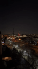 Tehran nighttime cityscape captured with illuminated tower, red building