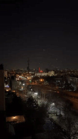 Tehran nighttime cityscape captured with illuminated tower, red building