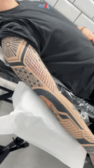 Man gets geometric tattoo sleeve in Sofia parlor