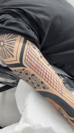Man gets geometric tattoo sleeve in Sofia parlor