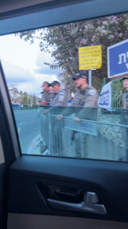 Police officers positioned at barricade in Haifa