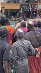 Street altercation around a trishaw draws crowd in Bukuru market