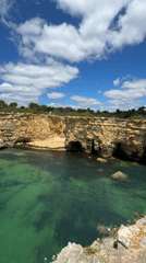 Coastal cove with golden cliffs and turquoise waters documented