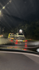 Tow truck carries two cars on rainy Bulgarian highway