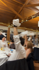 Restaurant celebration with napkin-waving in Vila Real, Portugal