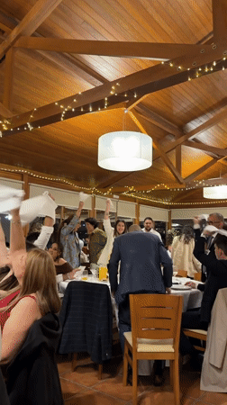 Restaurant celebration with napkin-waving in Vila Real, Portugal
