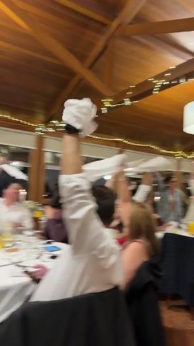 Restaurant celebration with napkin-waving in Vila Real, Portugal
