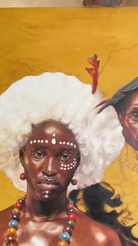 Artist paints traditional portrait in Ado studio using phone reference