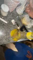 Person recorded using bong in Buenos Aires kitchen