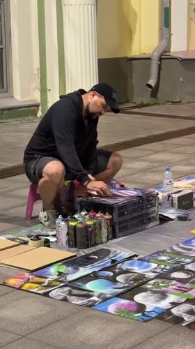 Street artist spray-painting on Nizhny Novgorod's main pedestrian strip