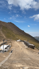 Summer day at a mountain ski resort, lifts running, slopes dry