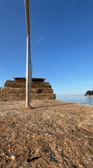 Woman climbs pier stairs to platform in Budva