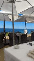 Sunny oceanfront dining captured in Teulada, Spain