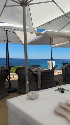 Sunny oceanfront dining captured in Teulada, Spain